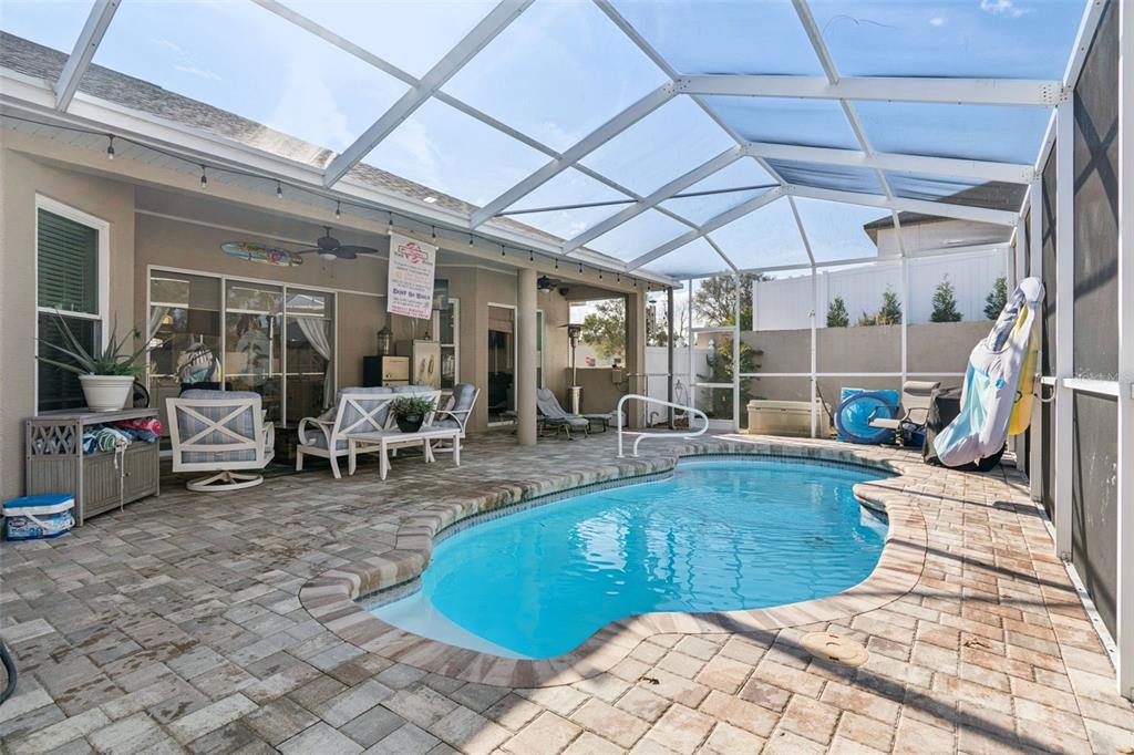 5287 Slater Road Spring Hill, FL 34608 - Photo 62 of 86 a view of a swimming pool with sitting area