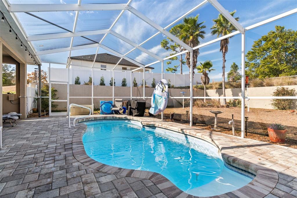 5287 Slater Road Spring Hill, FL 34608 - Photo 63 of 86 a view of a swimming pool with outdoor seating