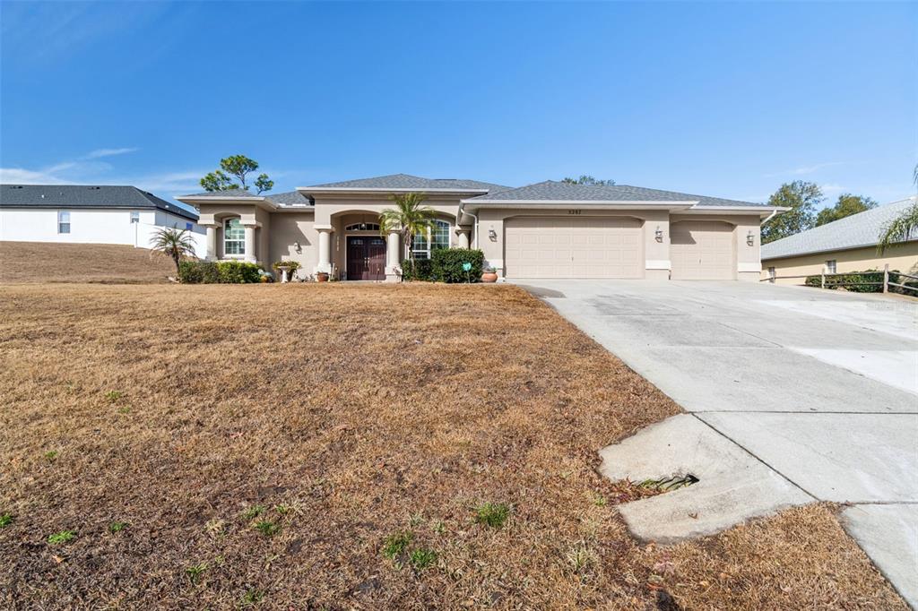 5287 Slater Road Spring Hill, FL 34608 - Photo 70 of 86 a front view of a house with a yard