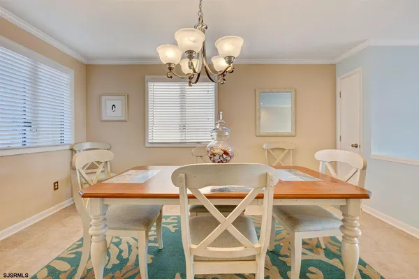 a view of a dining room with furniture and chandelier