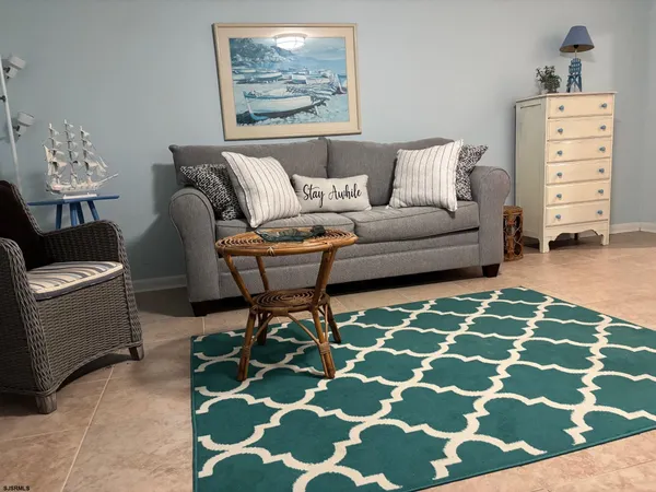 a living room with furniture and a rug