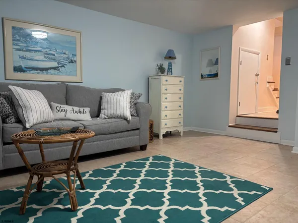 a living room with furniture and a rug