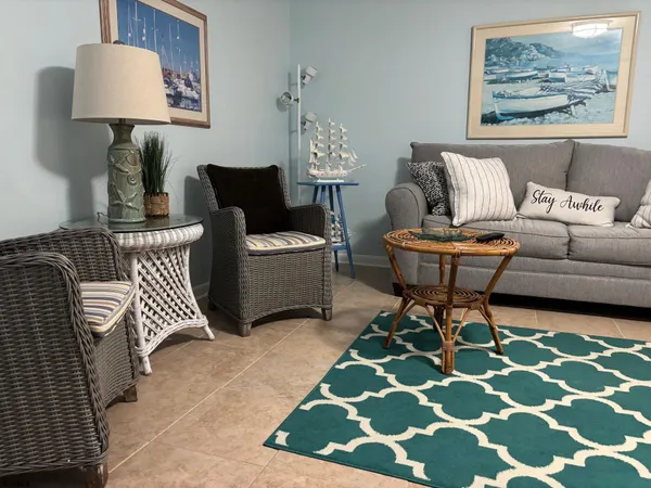 a living room with furniture and a rug