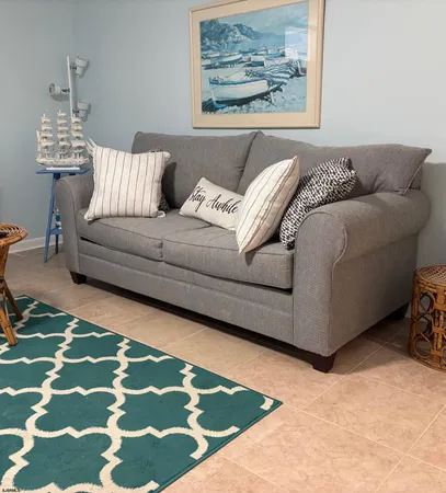 a living room with a couch and a rug