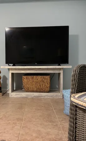 a living room with a flat screen tv and a fireplace