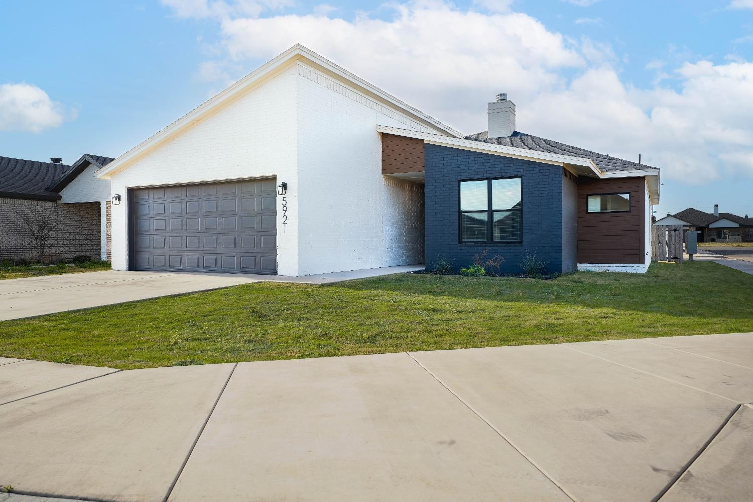a view of a house with a yard and garage