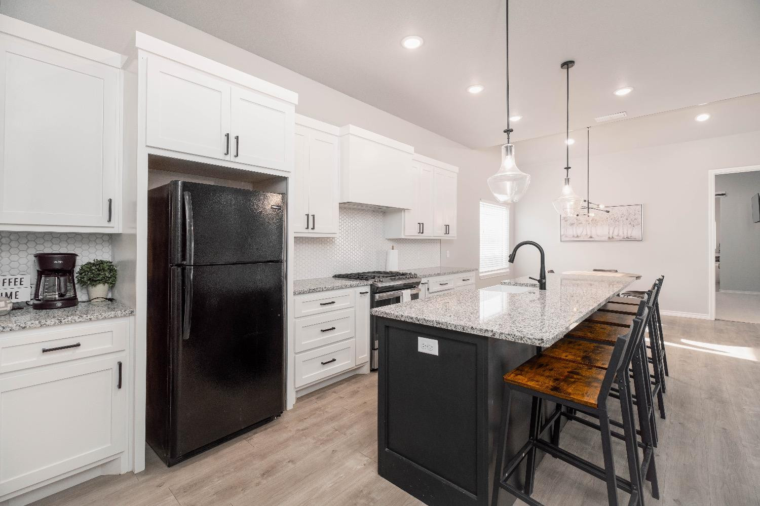 5921 Harvard Street Lubbock, TX 79416 - Photo 12 of 34 a kitchen with granite countertop a sink appliances a counter space and cabinets