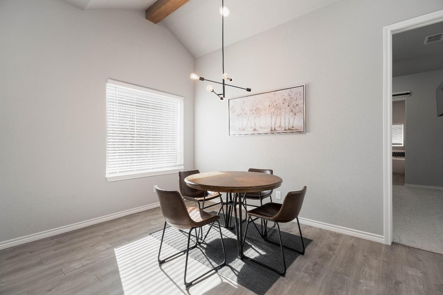 5921 Harvard Street Lubbock, TX 79416 - Photo 16 of 34 a view of a dining room with furniture and wooden floor