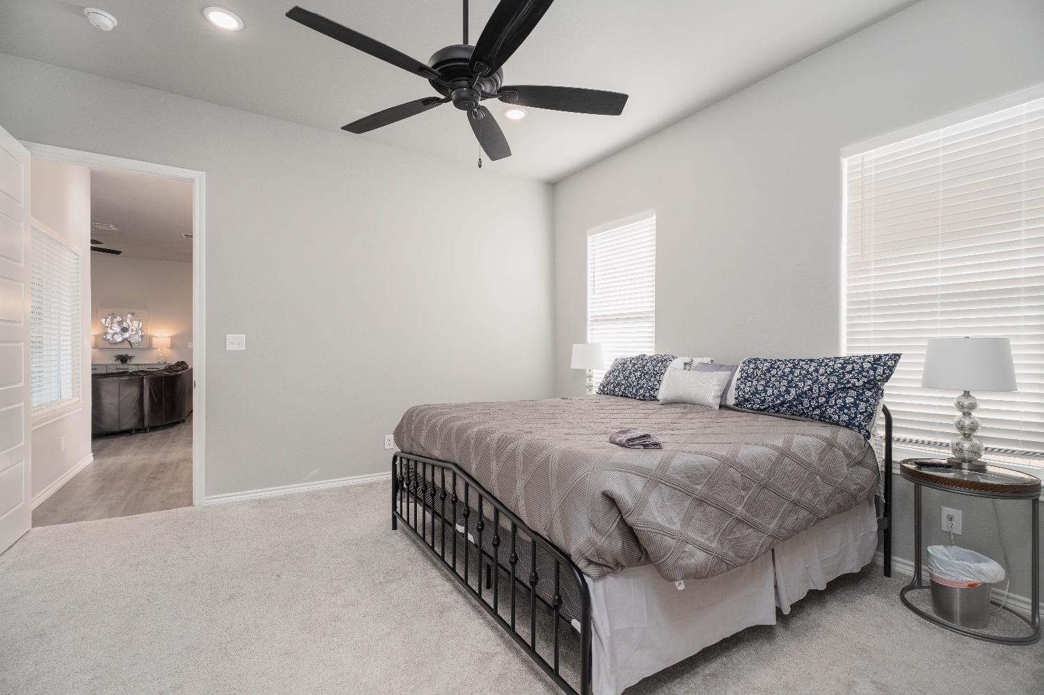 5921 Harvard Street Lubbock, TX 79416 - Photo 20 of 34 a bedroom with a bed and a chandelier