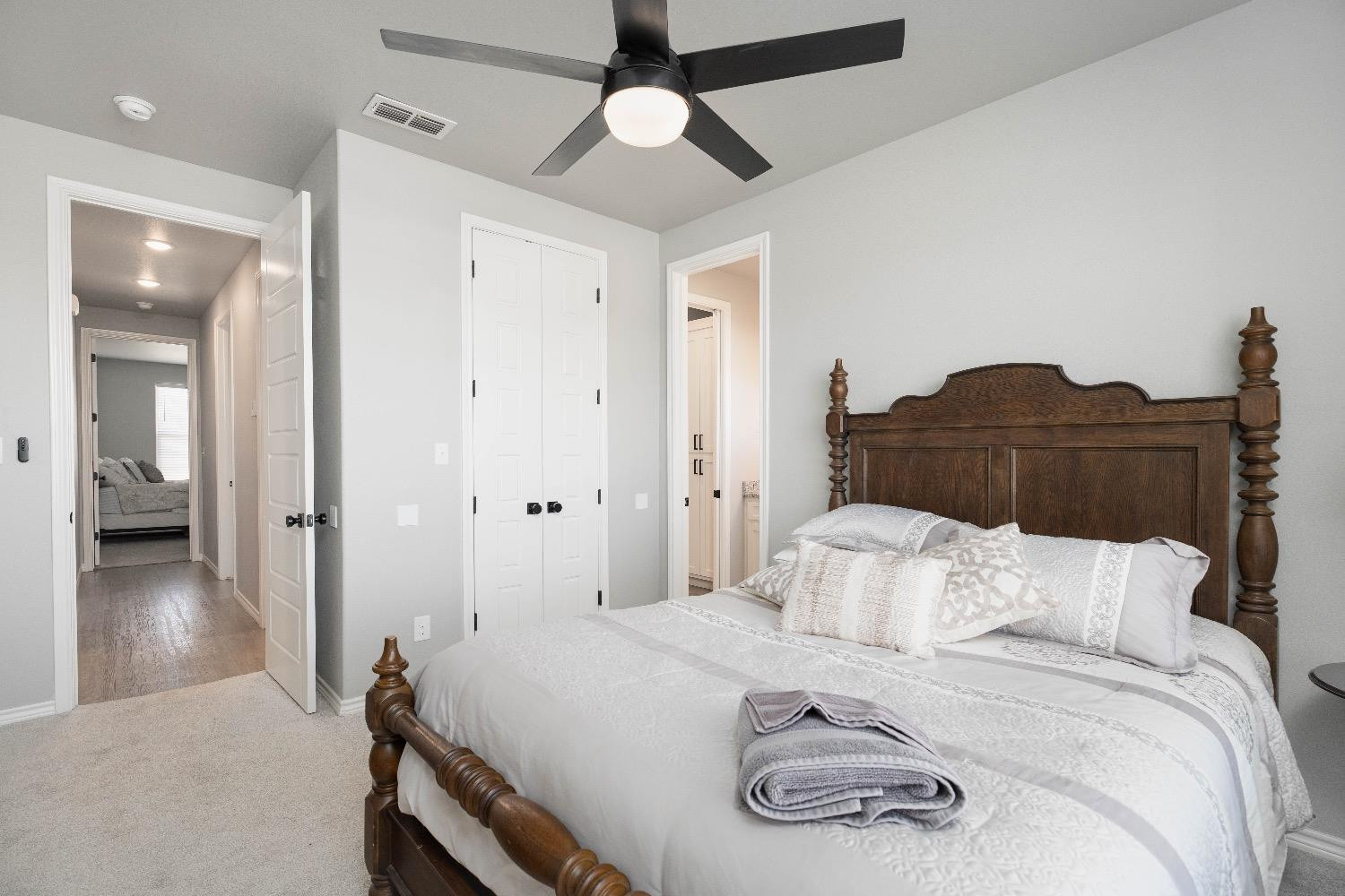 5921 Harvard Street Lubbock, TX 79416 - Photo 26 of 34 a bedroom with a bed and a chandelier