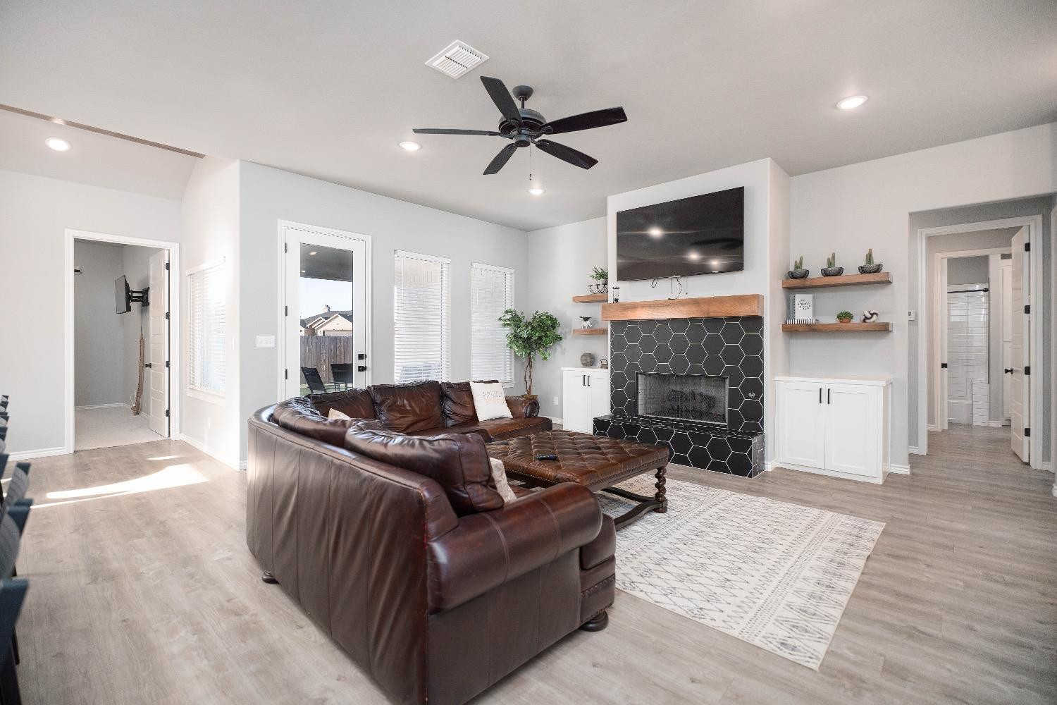 5921 Harvard Street Lubbock, TX 79416 - Photo 6 of 34 a living room with furniture and a fireplace