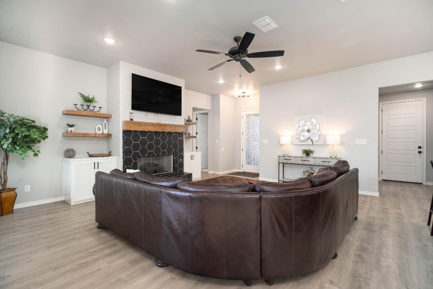 5921 Harvard Street Lubbock, TX 79416 - Photo 7 of 34 a living room with fireplace furniture and a flat screen tv