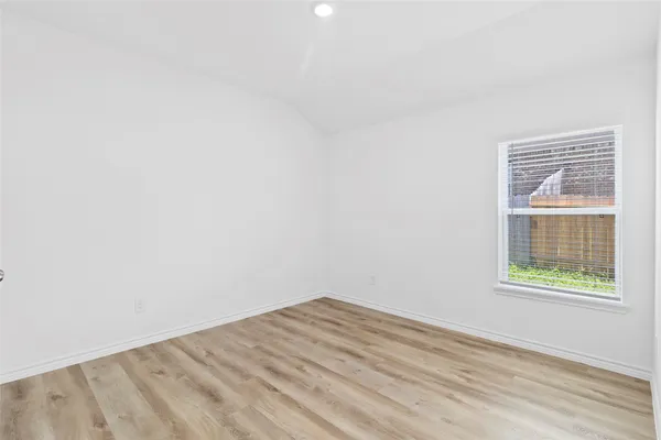 a view of a room with wooden floor and windows