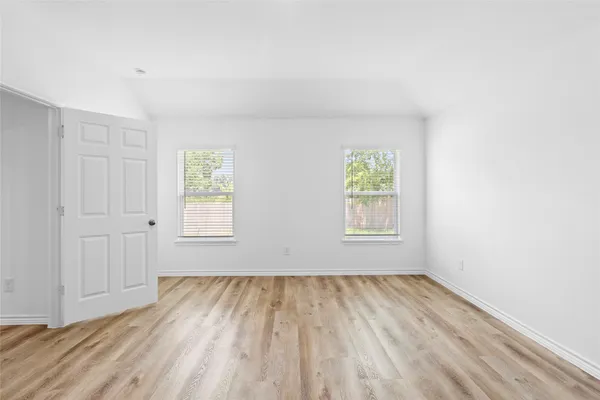 a view of room with window and hardwood floor