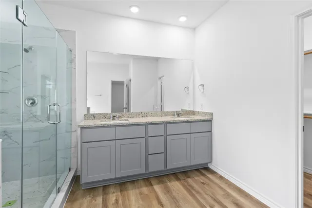 a bathroom with double vanity sink and mirror