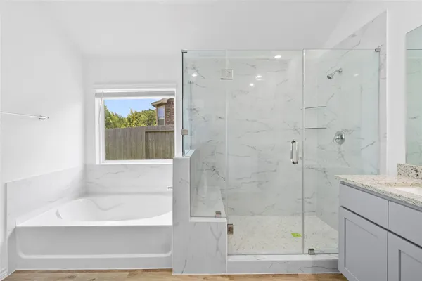 a bathroom with a bathtub and a shower
