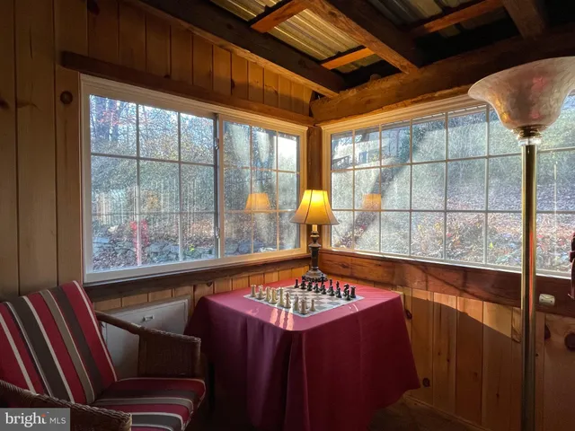 a view of a backyard with wooden fence and large trees