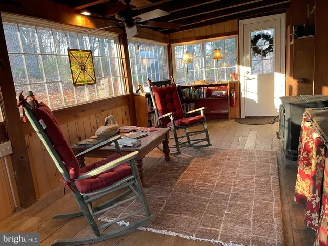 a view of a dining room with furniture and floor to ceiling window