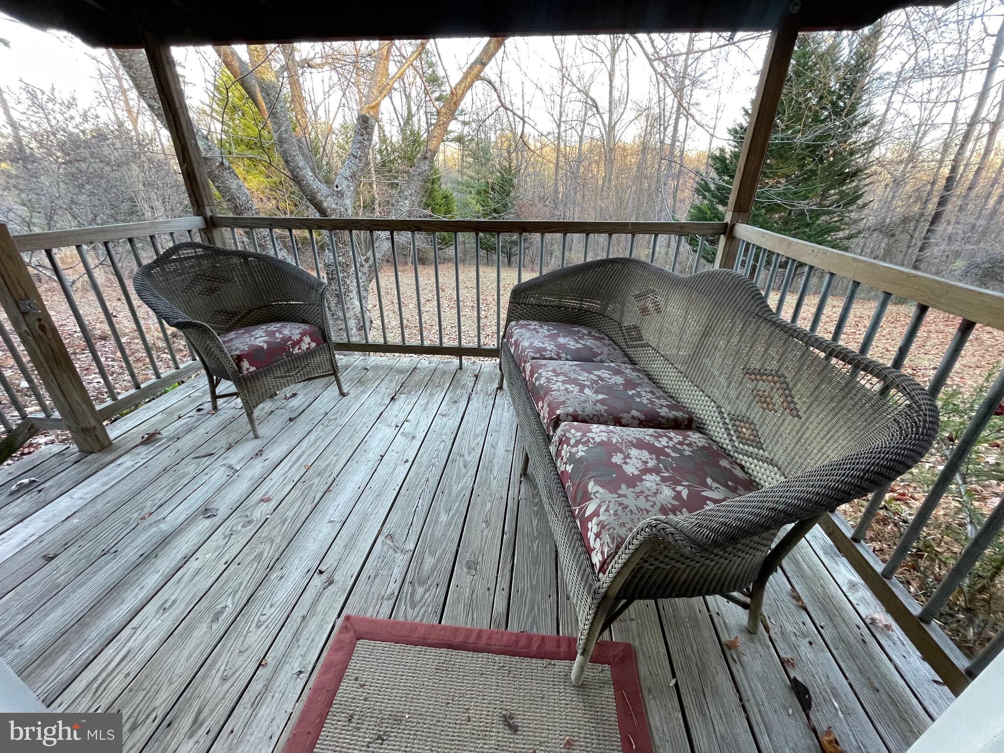 59 Angel Kiss Lane Castleton, VA 22716 - Photo 17 of 18 a view of balcony with wooden floor and outdoor seating