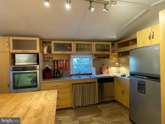 a kitchen with refrigerator and window