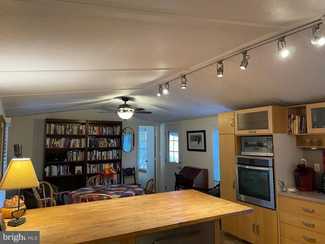 a bedroom with a bed and a mirror on the dresser