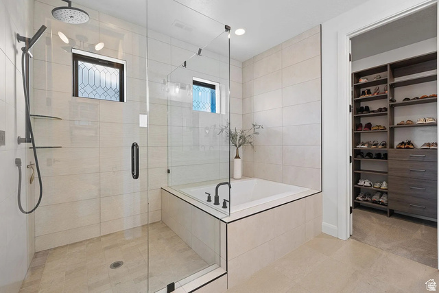 11617 South Wildrye Field Way Draper, UT 84020 - Photo 21 of 53 Full bathroom with a stall shower, a garden tub, a spacious closet, and light tile patterned flooring