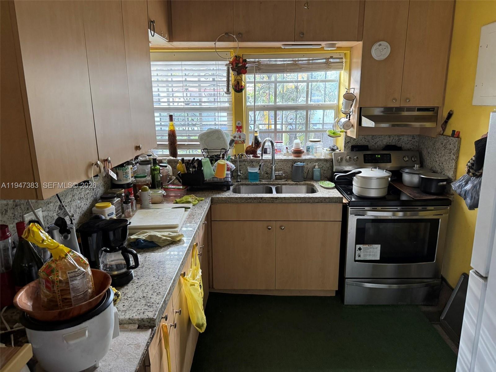 790 Northwest 76th Street Miami, FL 33150 - Photo 2 of 10 a kitchen with a sink stove and cabinets