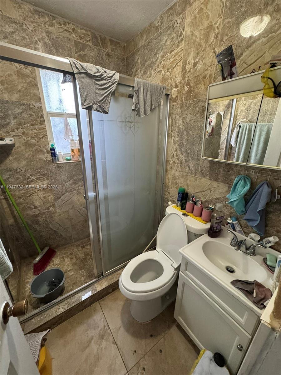 790 Northwest 76th Street Miami, FL 33150 - Photo 4 of 10 a white toilet sitting next to a bathroom sink