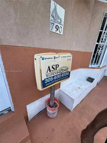 a view of a backyard with sitting area and tree