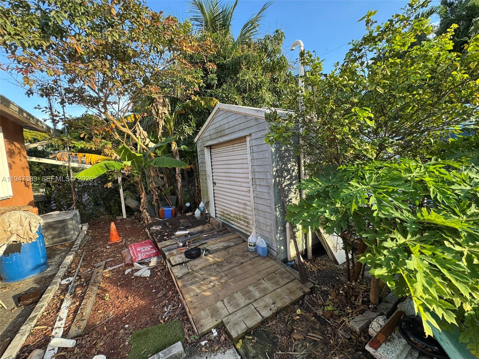 790 Northwest 76th Street Miami, FL 33150 - Photo 7 of 10 a view of a backyard with sitting area and tree