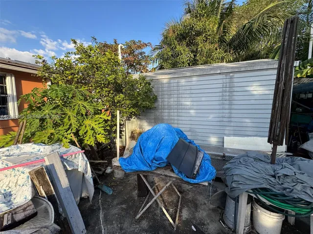 an outdoor view of house with backyard