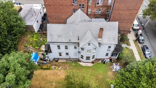 an aerial view of residential house with yard and swimming pool