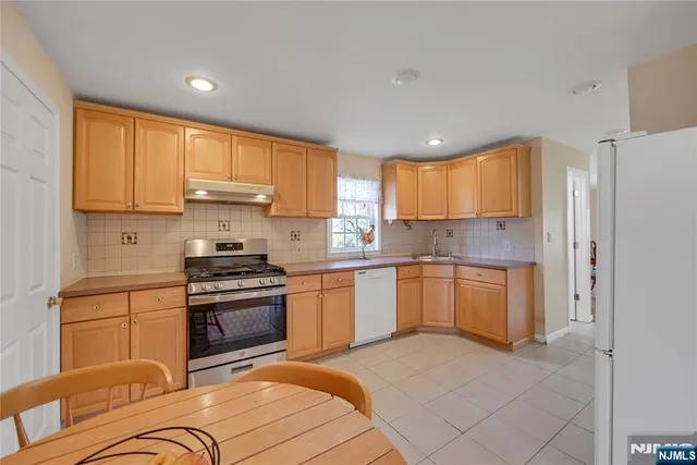 a view of a livingroom with wooden floor and stairs