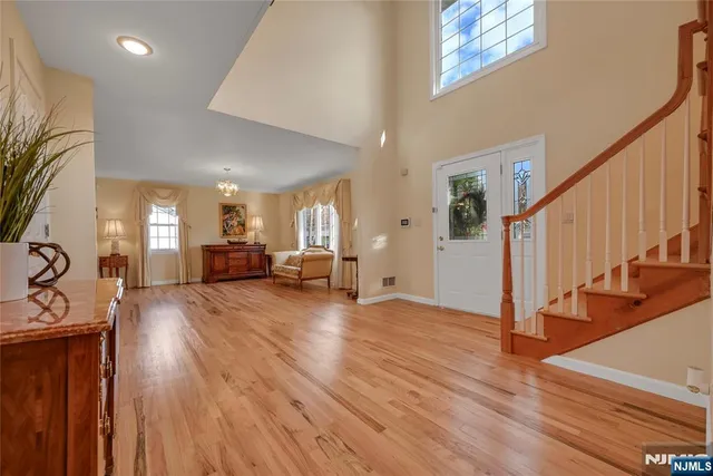 a furnished livingroom with windows and wooden floor
