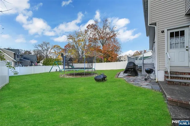 a view of a house with backyard and a sitting area