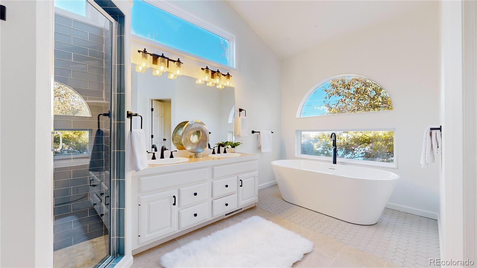 357 Harrison Street Denver, CO 80206 - Photo 13 of 40 a bathroom with a double vanity sink and a mirror