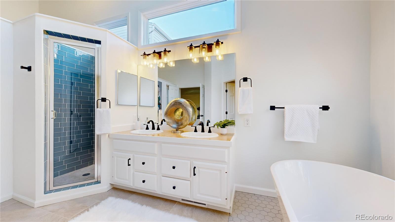 357 Harrison Street Denver, CO 80206 - Photo 15 of 40 a bathroom with a tub sink and mirror