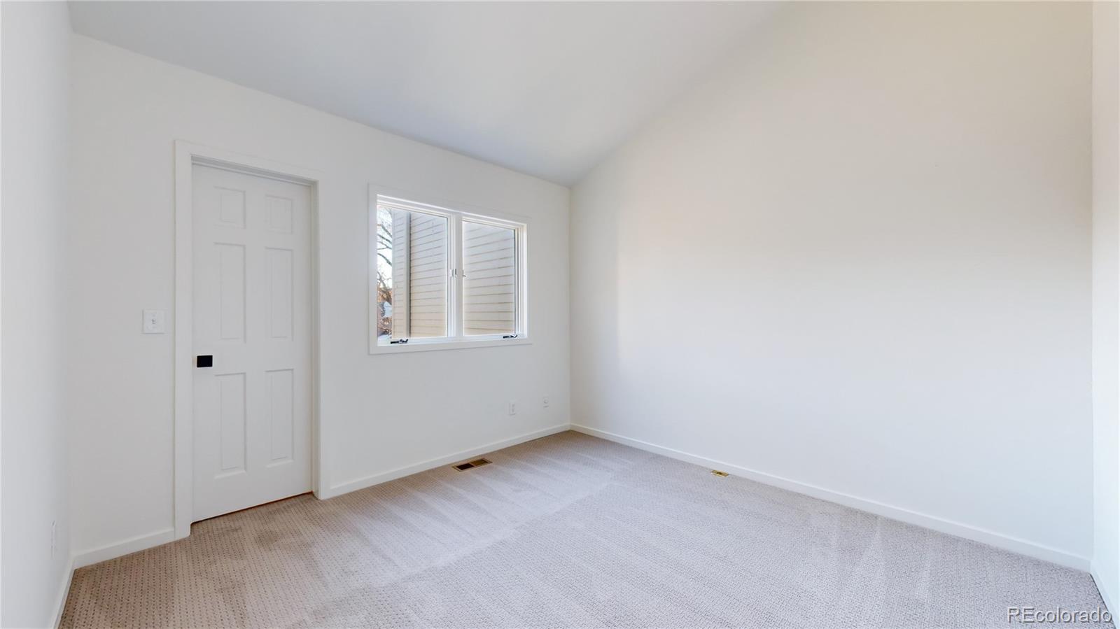 357 Harrison Street Denver, CO 80206 - Photo 18 of 40 an empty room with windows