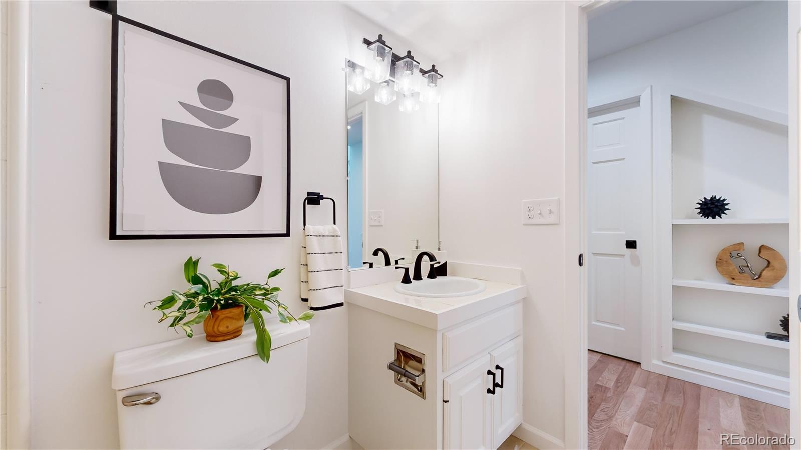 357 Harrison Street Denver, CO 80206 - Photo 20 of 40 a bathroom with a sink a mirror and a shower curtain
