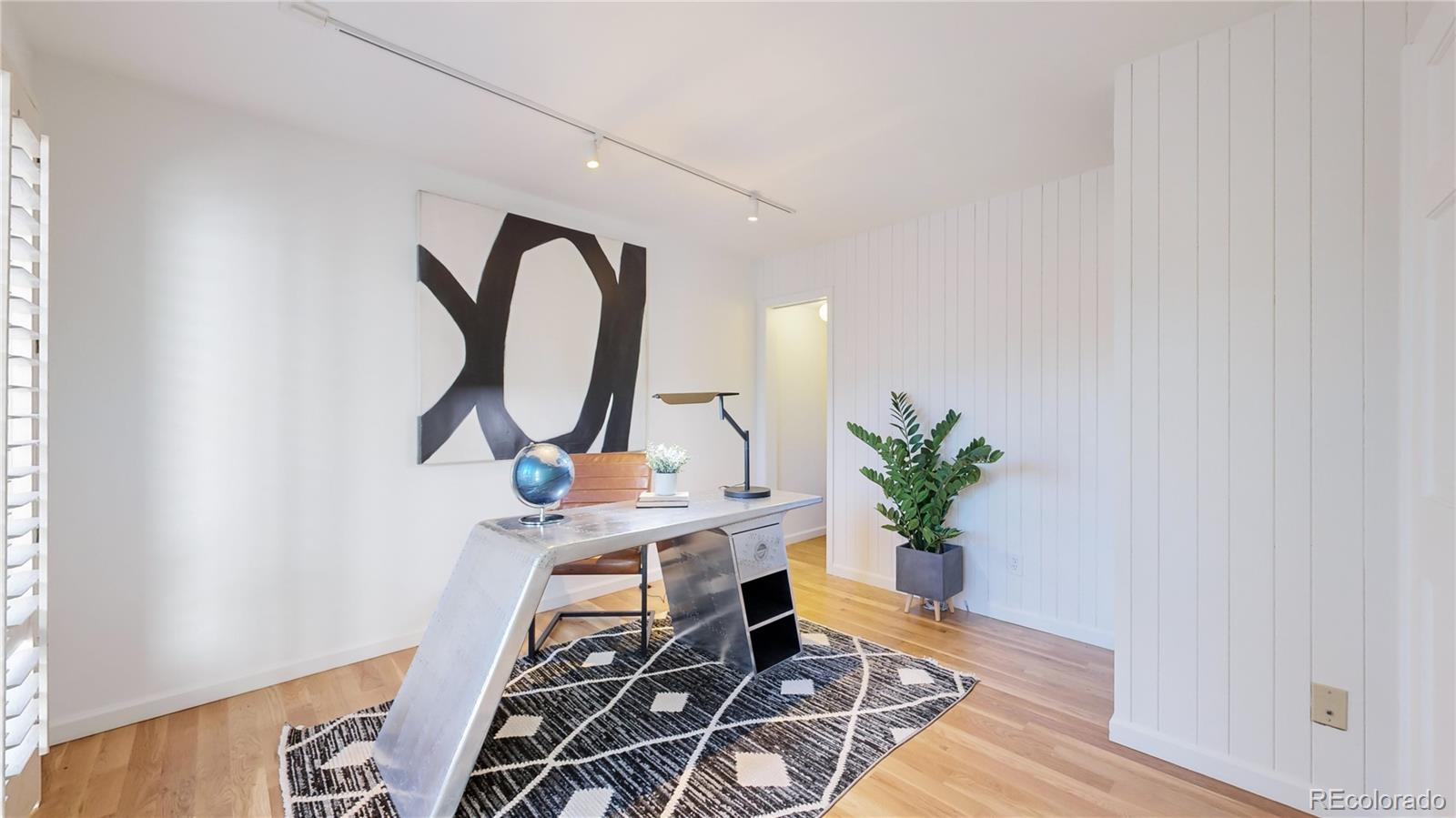 357 Harrison Street Denver, CO 80206 - Photo 21 of 40 a living room with furniture a potted plant and a wooden floor