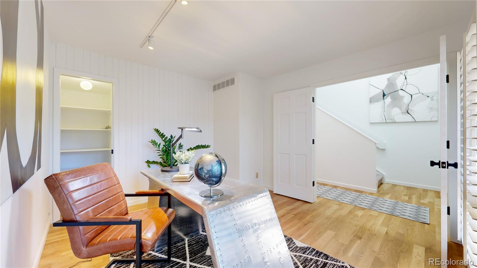 357 Harrison Street Denver, CO 80206 - Photo 22 of 40 a view of a dining room with furniture and a potted plant