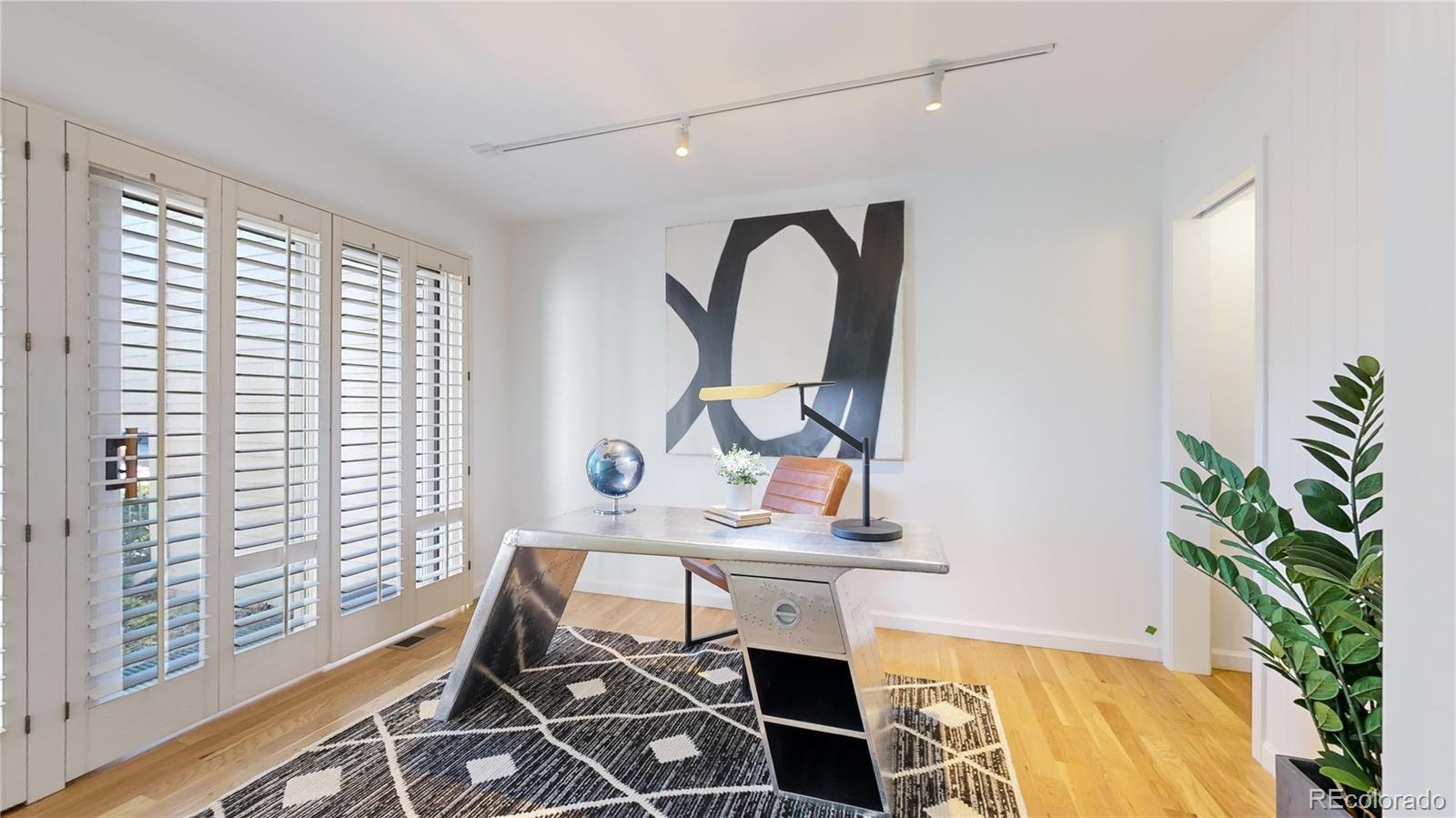357 Harrison Street Denver, CO 80206 - Photo 23 of 40 a view of a workspace room with furniture and a potted plant
