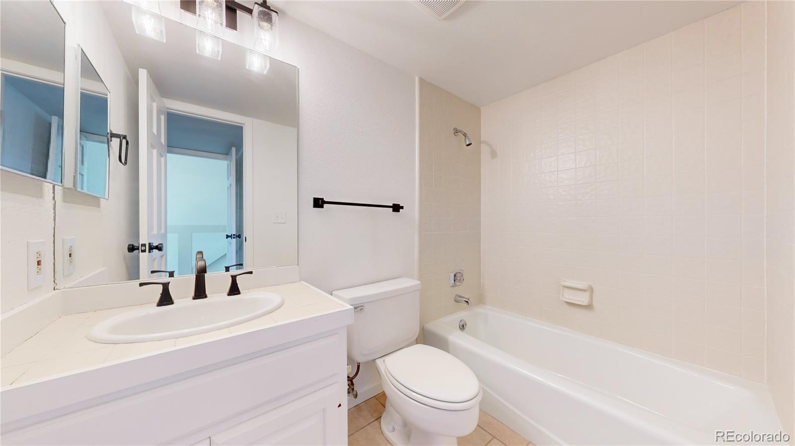 357 Harrison Street Denver, CO 80206 - Photo 25 of 40 a bathroom with a sink a toilet and shower