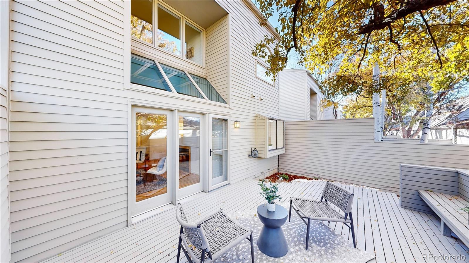 357 Harrison Street Denver, CO 80206 - Photo 27 of 40 a view of a patio with a table and chairs and wooden floor