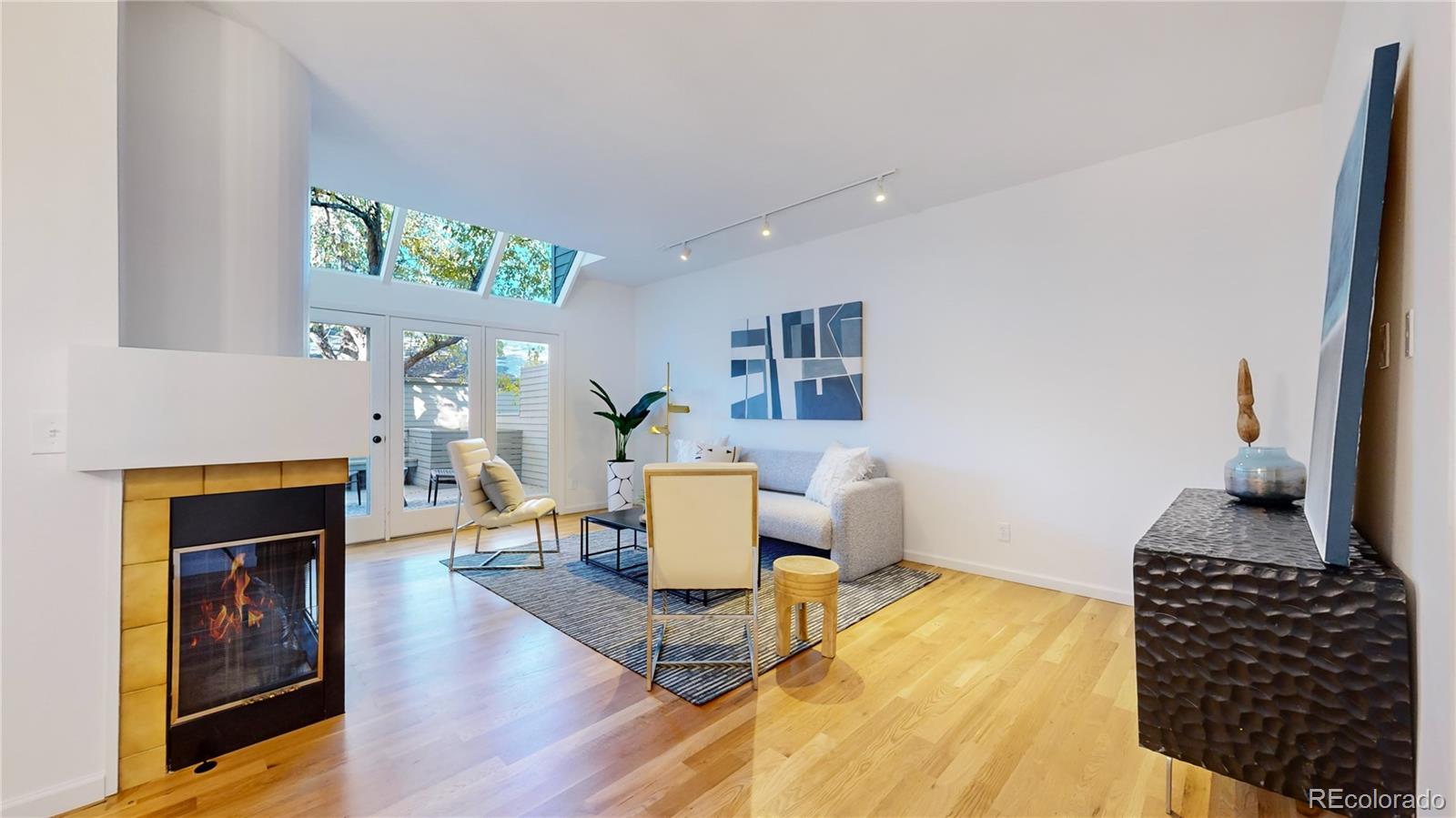 357 Harrison Street Denver, CO 80206 - Photo 3 of 40 a living room with furniture and a fireplace