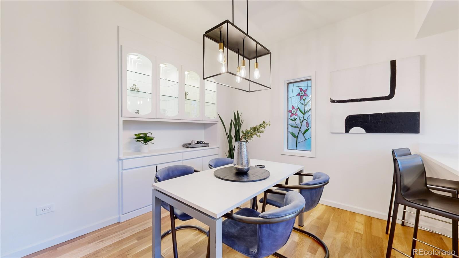 357 Harrison Street Denver, CO 80206 - Photo 6 of 40 a view of a dining room with furniture and wooden floor