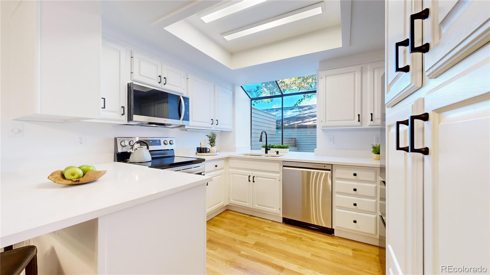 357 Harrison Street Denver, CO 80206 - Photo 7 of 40 a kitchen with cabinets stainless steel appliances and window