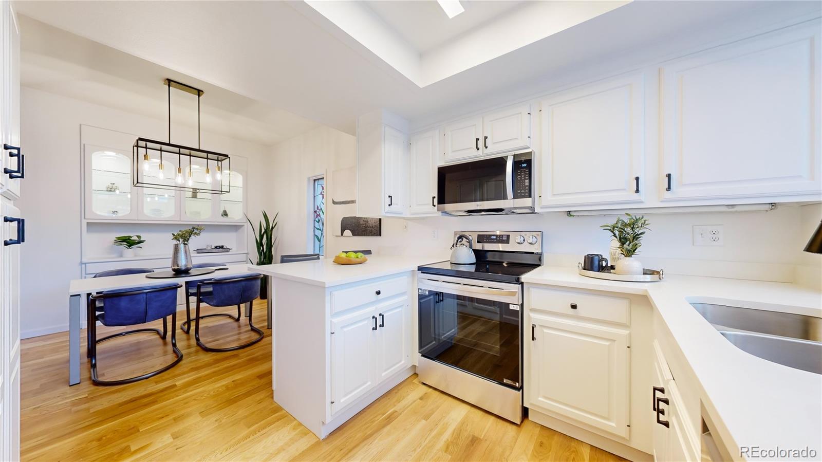 357 Harrison Street Denver, CO 80206 - Photo 8 of 40 a kitchen with cabinets appliances and a counter top space