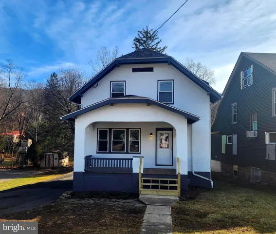 wooden floor fireplace and windows in an empty room