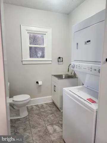 a bathroom with a sink a toilet and bathtub